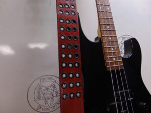 ANGUS YOUNG...   LEATHER RED BLOODED  GROMMET GUITAR STRAP  Australia  (MDLS0392)